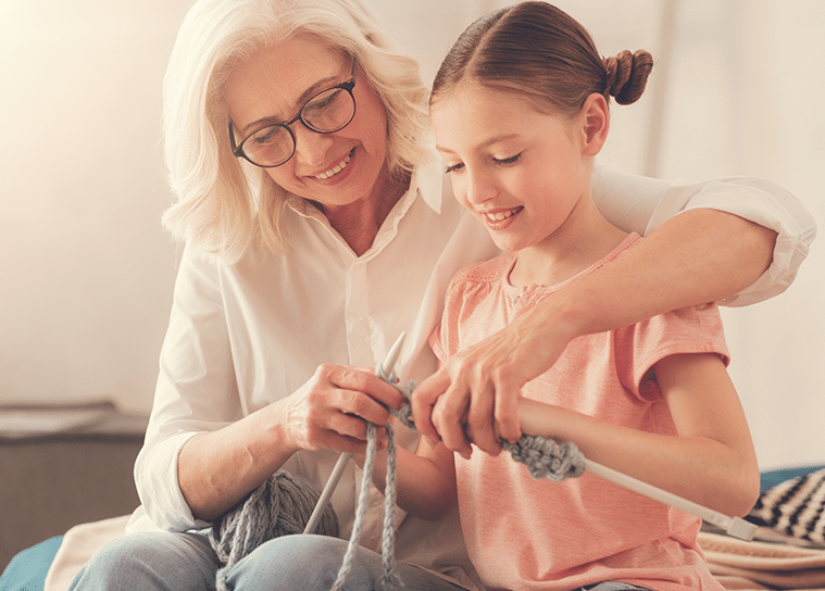 Grandmother knitting with granddaughter for legal guardianship webpage banner
