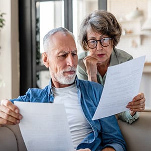 Senior couple reviewing legal documents for will or trust