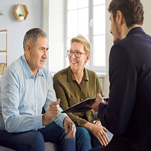 Senior couple consulting with attorney at law office desk