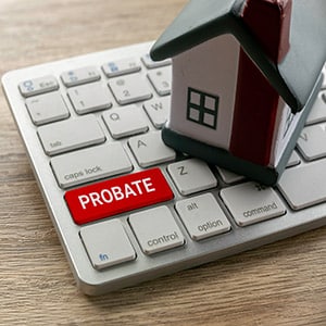 Probate key on computer keyboard with small house model
